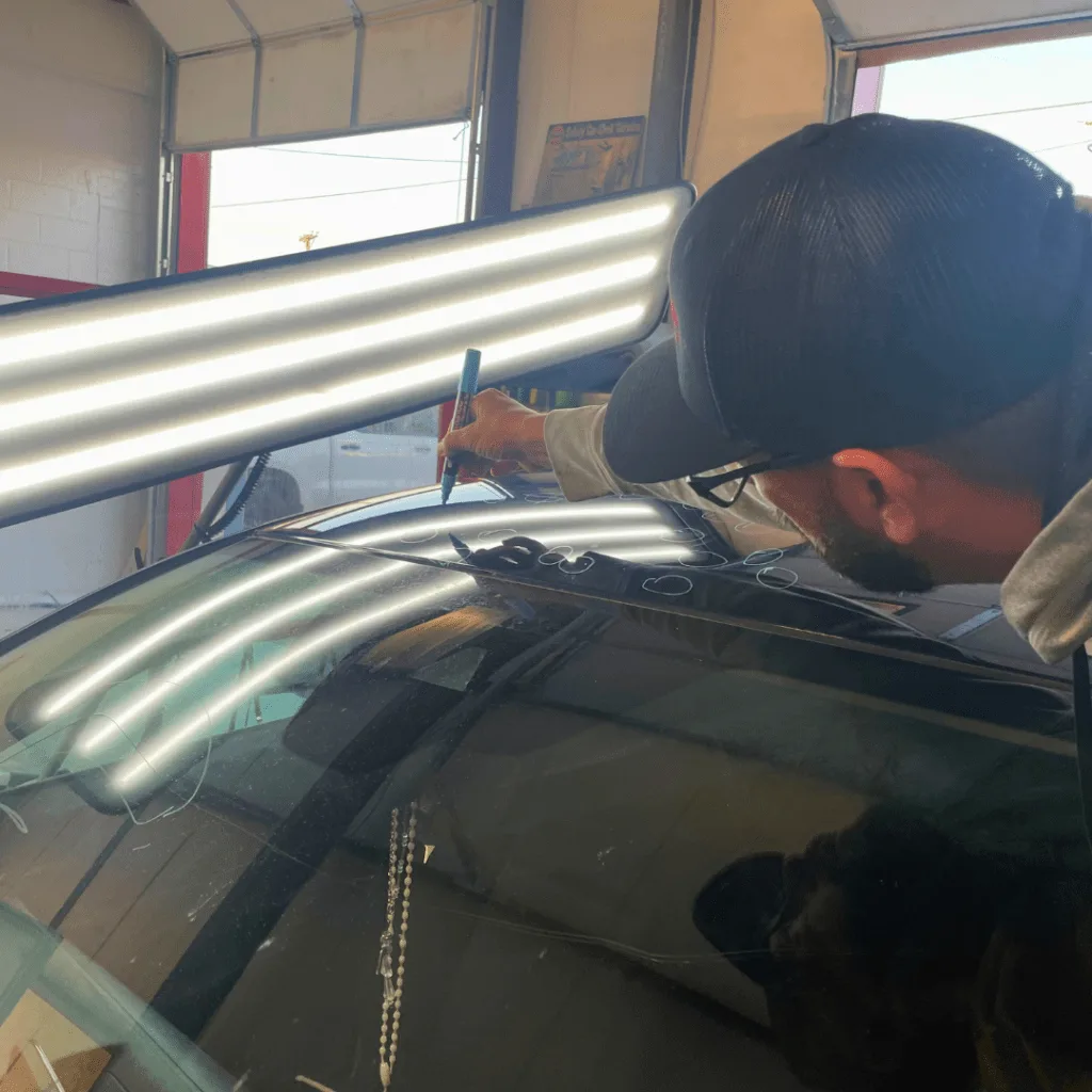 Hail damaged vehicle being repaired at AGC